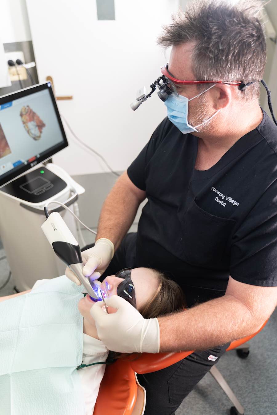 Dentist Glen Harvey reviewing fillings